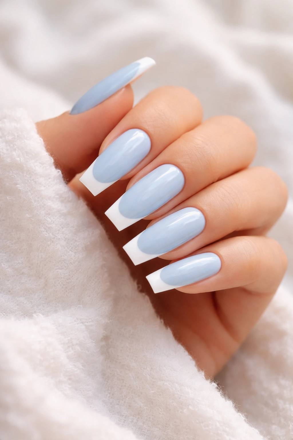 Baby blue coffin nails with white tips on long nails.