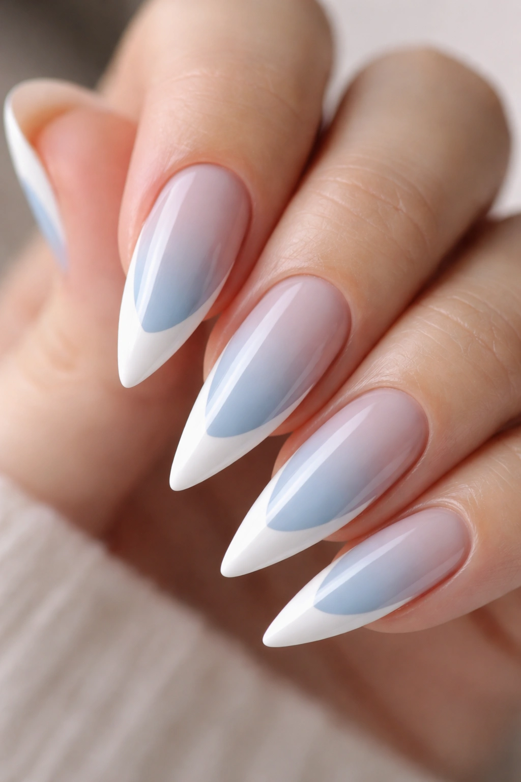 Close-up of baby blue stiletto nails with white French tips
