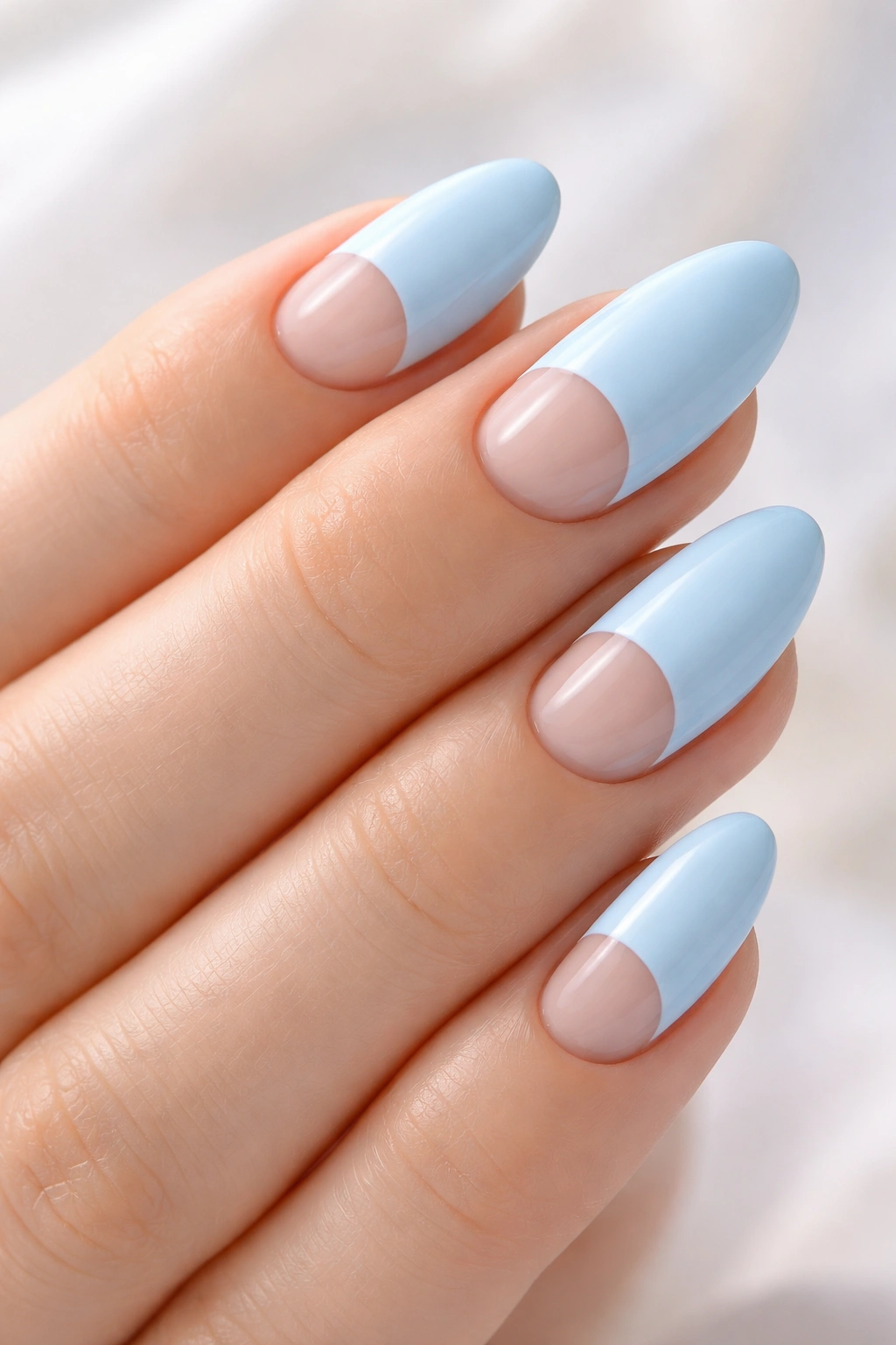 Baby blue nails with negative-space half-moon at base