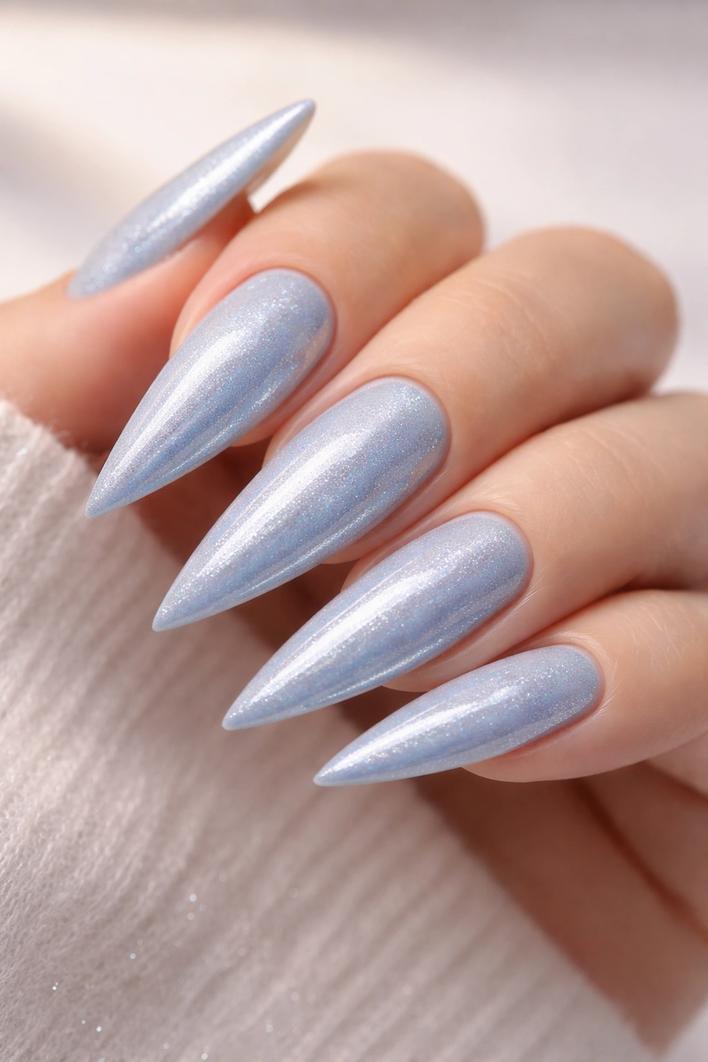 Baby blue nails with silver shimmer on long stiletto nails