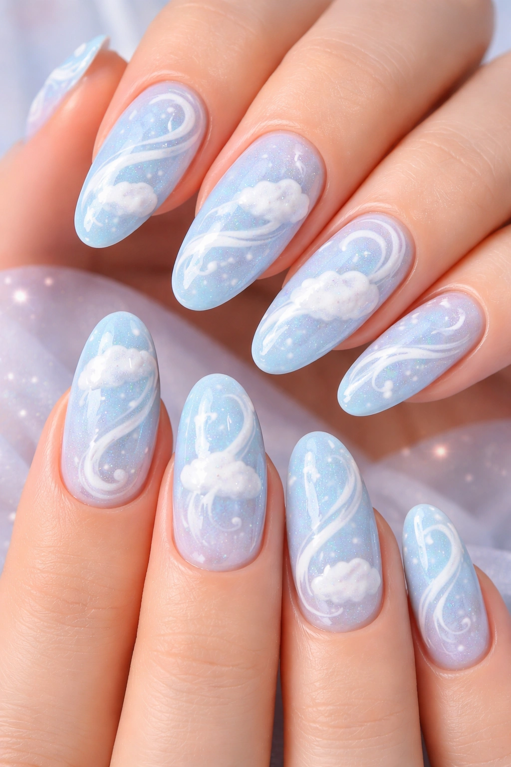 Close-up of baby blue nails with white cloud-like swirls