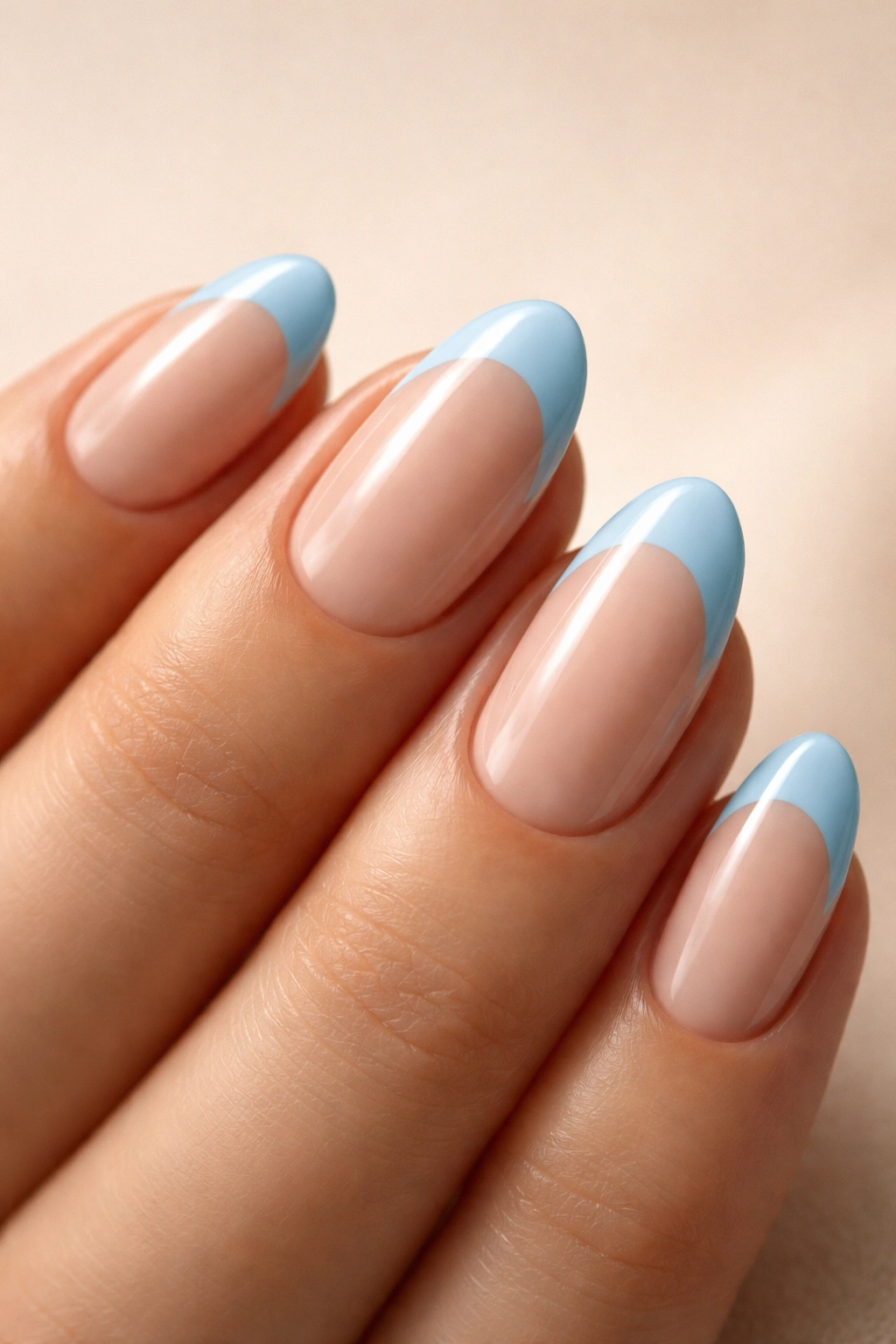 Short almond nail with baby blue tip on nude base