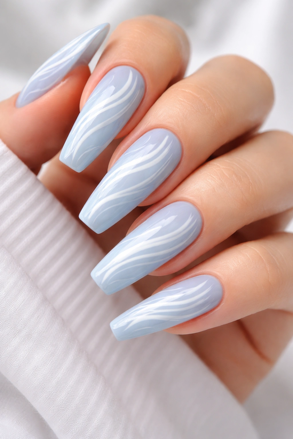 Long nails with baby blue base and white swirl marbling