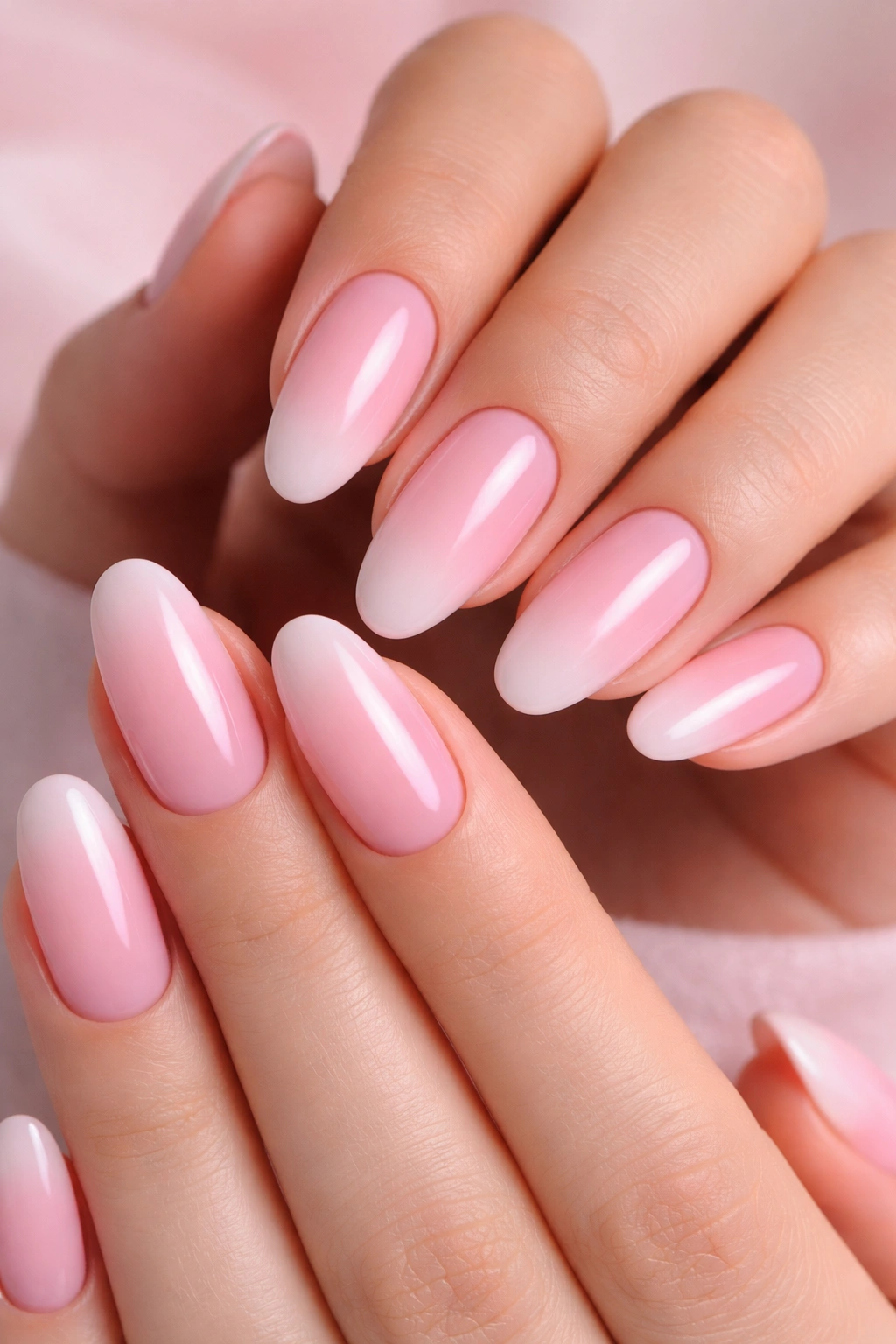 Close-up of ombré nails fading from baby pink to white
