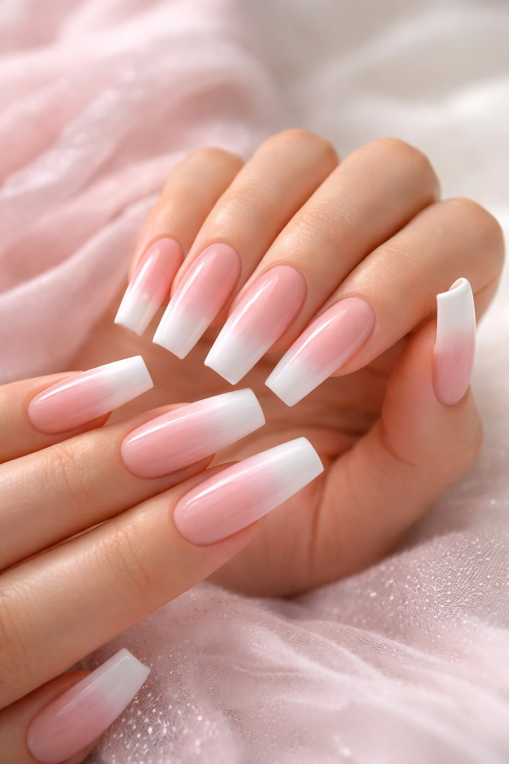 Baby pink to white ombré French tips on long coffin nails