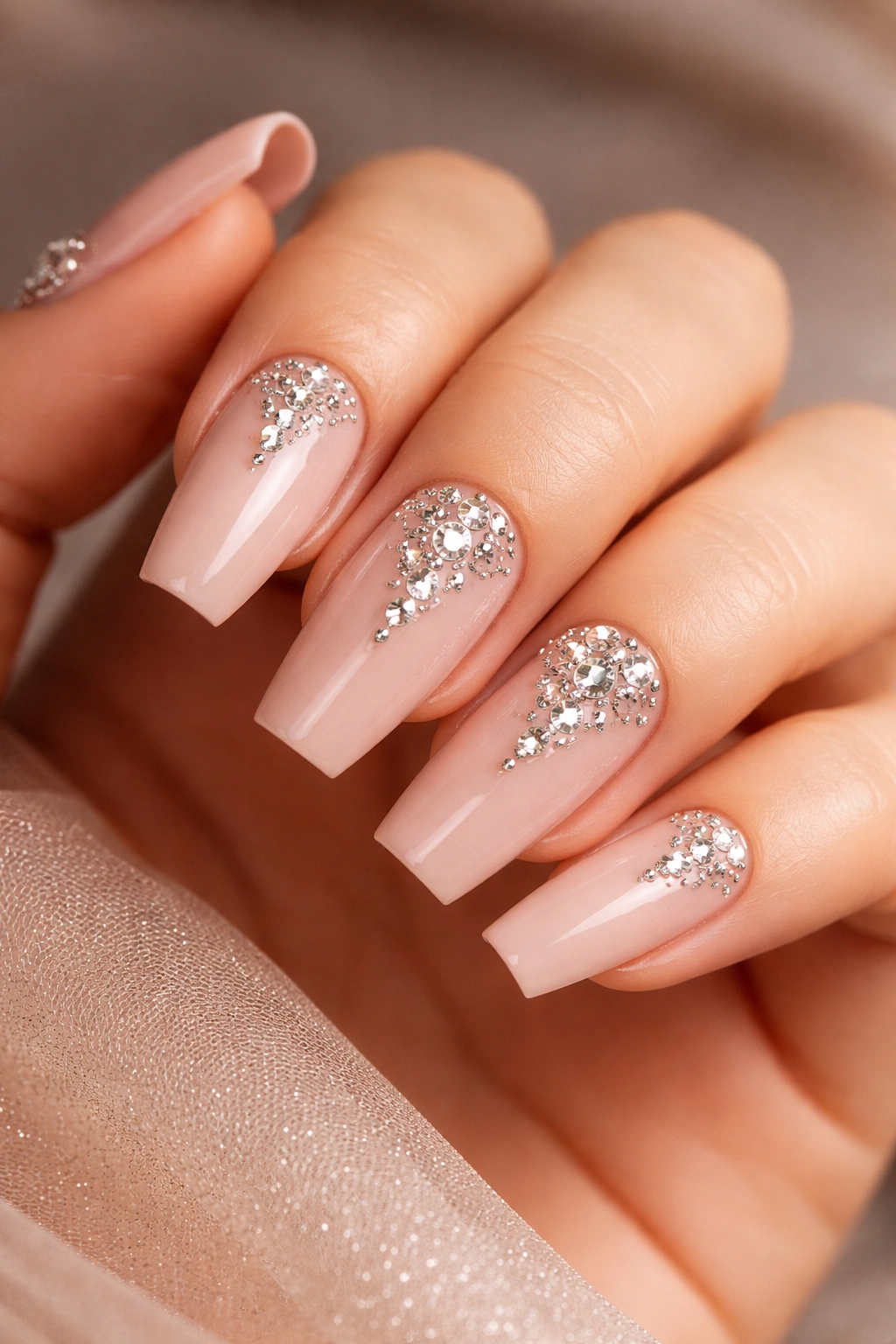 Close-up of ballet nude coffin nails with diamond-cut rhinestones