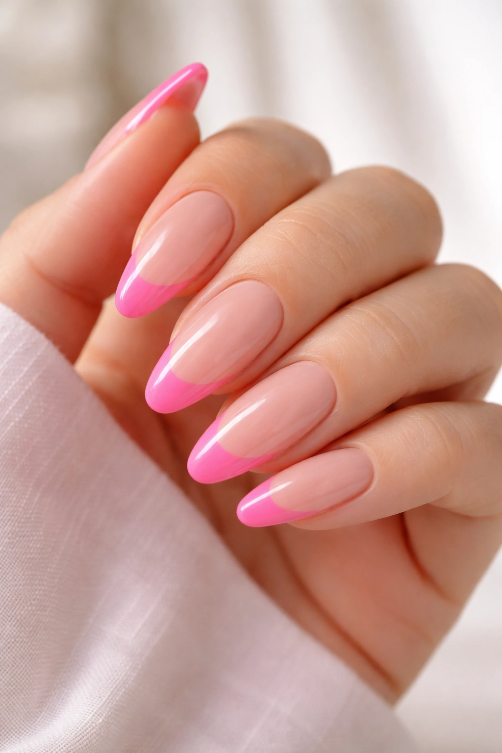 Almond nails with bright Barbie pink tips on nude base