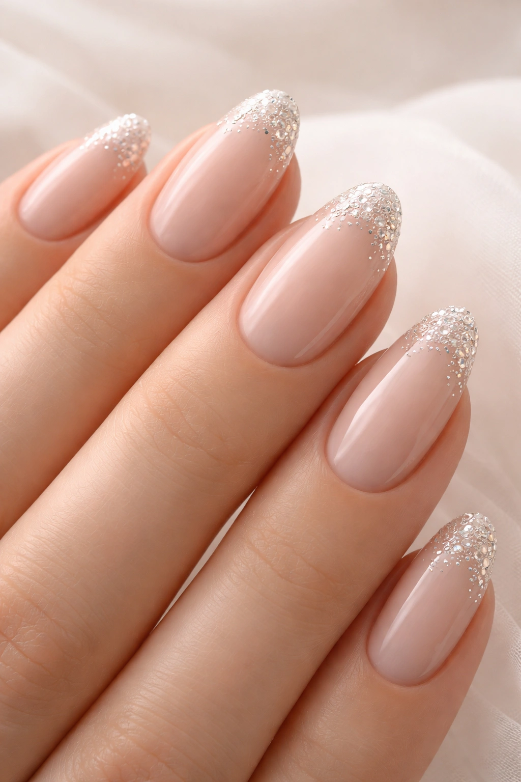 Nails with nude base and rhinestone tips