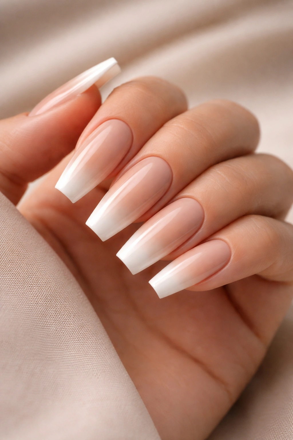 Coffin nails with soft beige to tan to white gradient and glossy finish