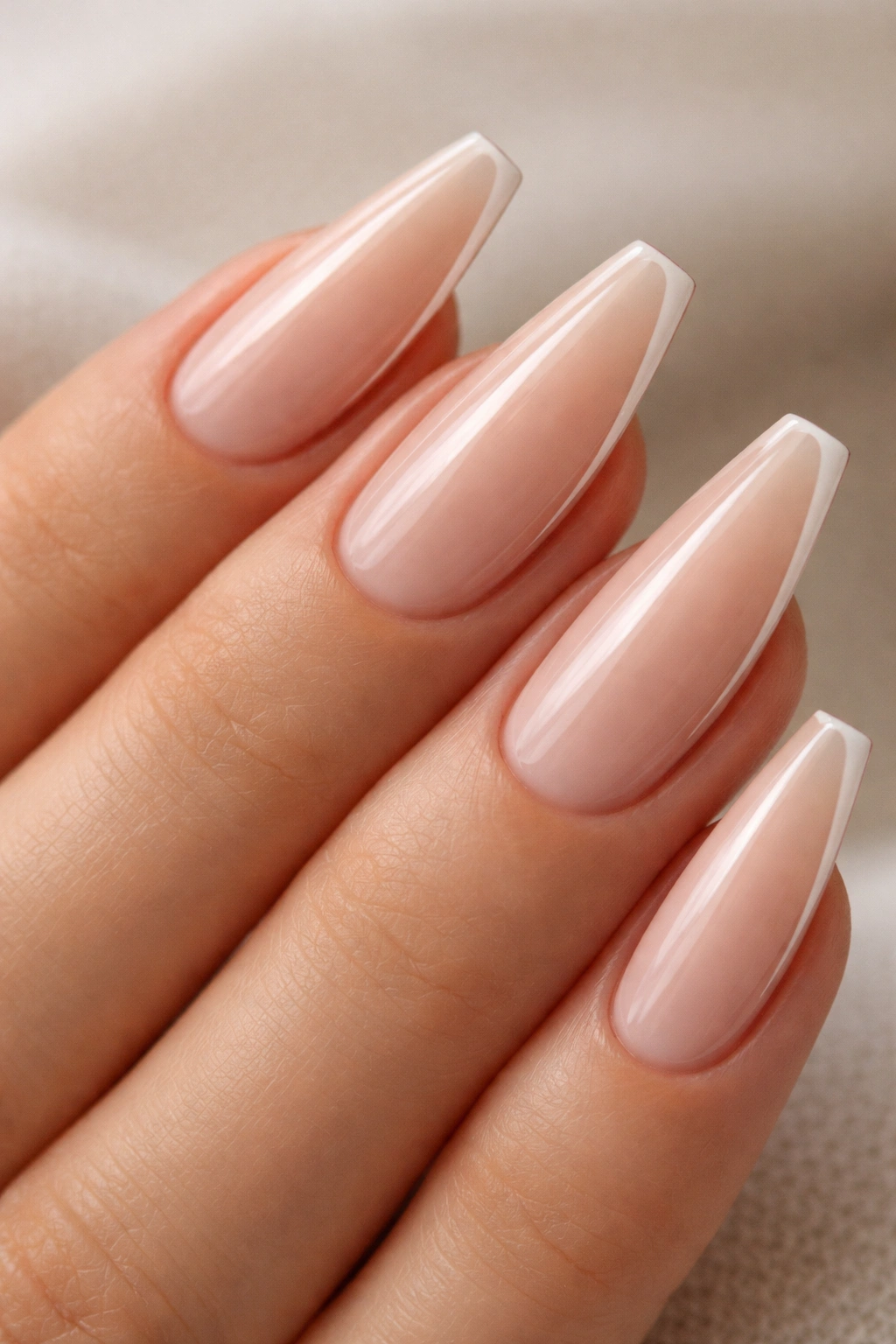 Close-up of beige minimalist ballerina nails with ultrathin side French