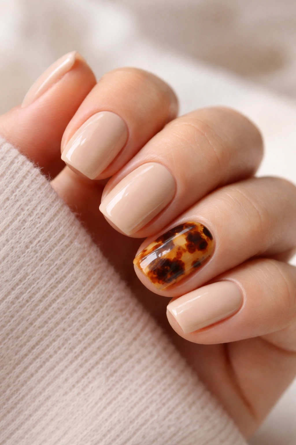 Beige nails with tortoiseshell accent on one or two nails