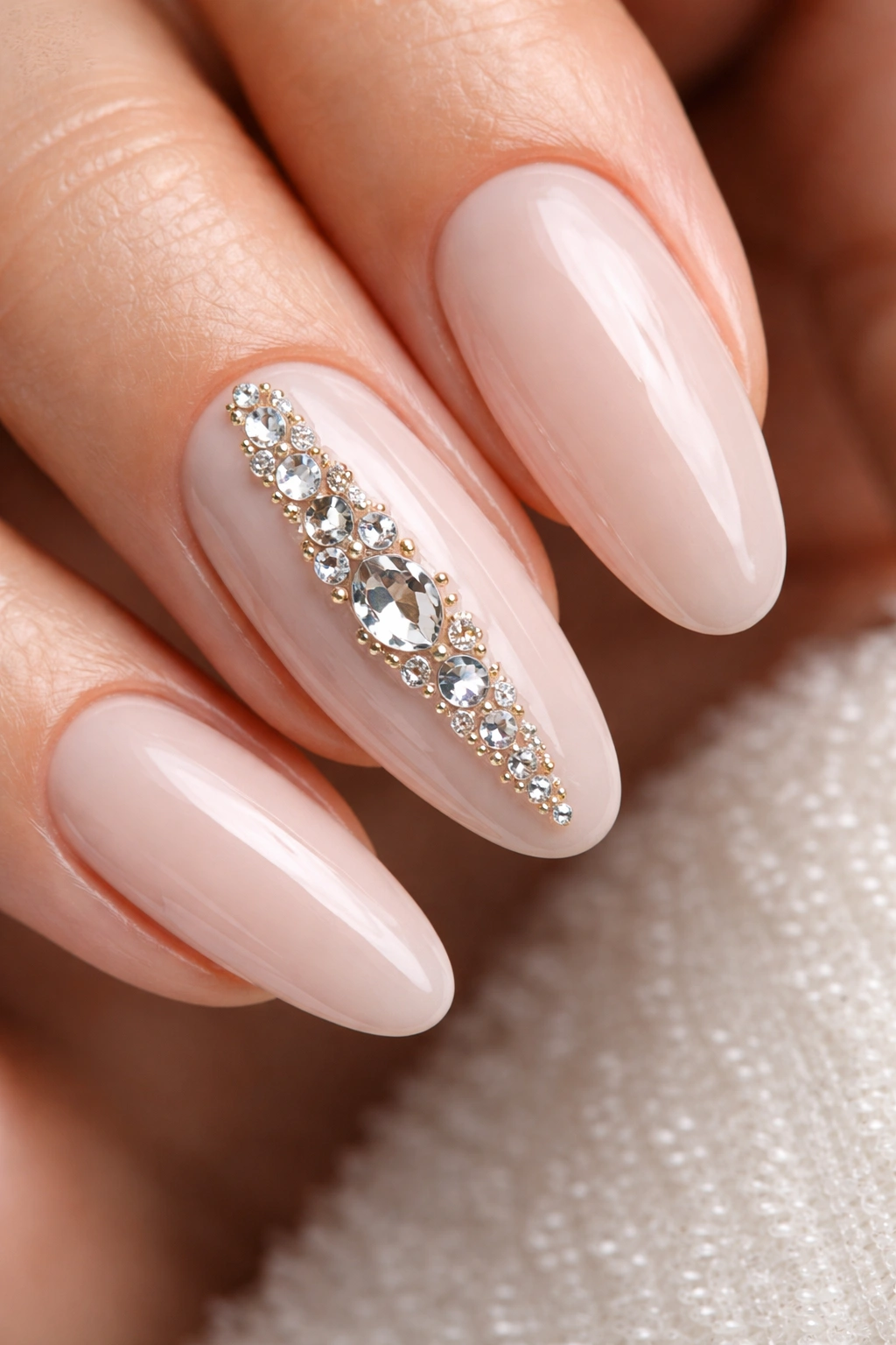 Nude-base nail with a jewel-studded accent nail