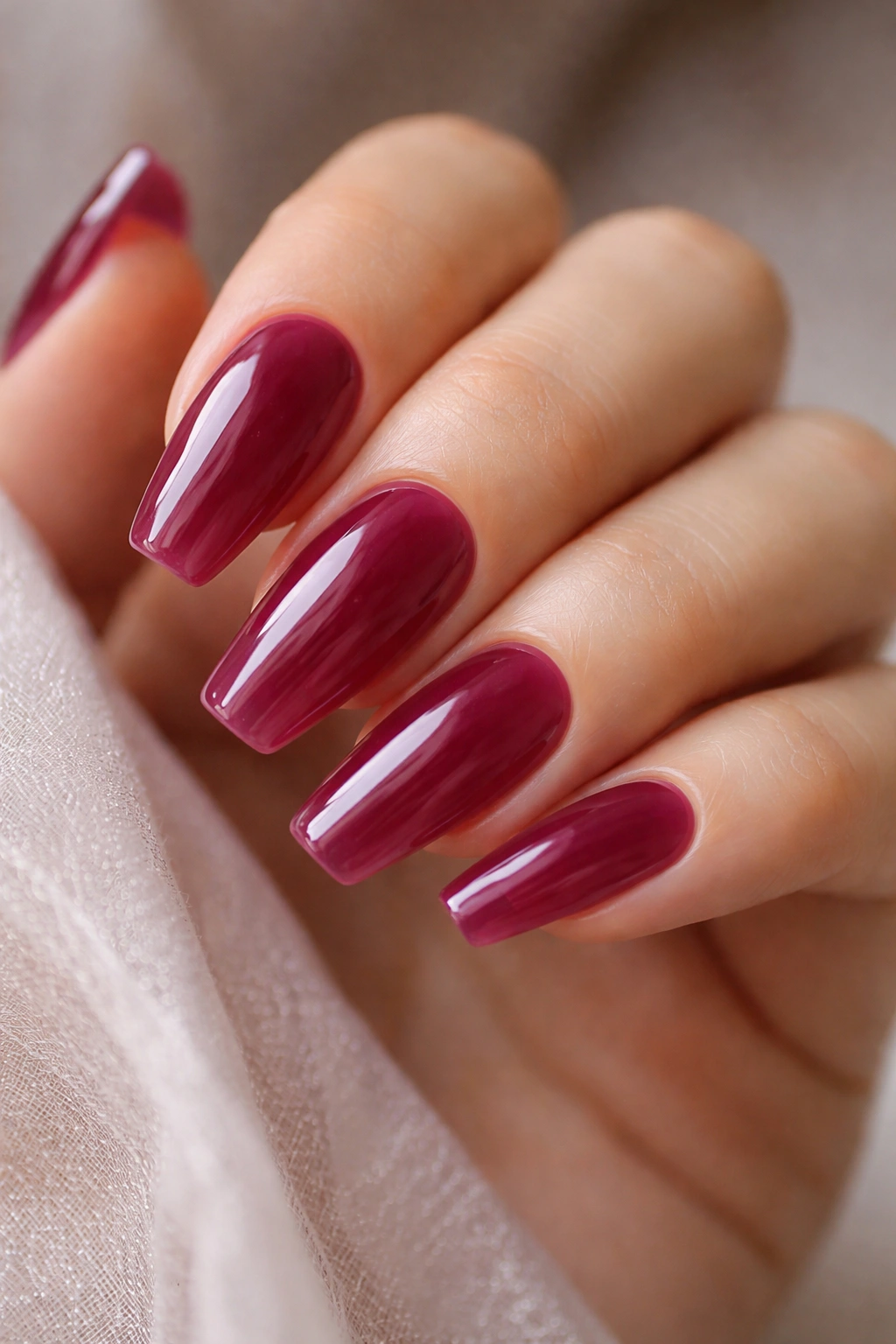 Deep berry jelly nails with translucent finish on medium-length ballerina nails