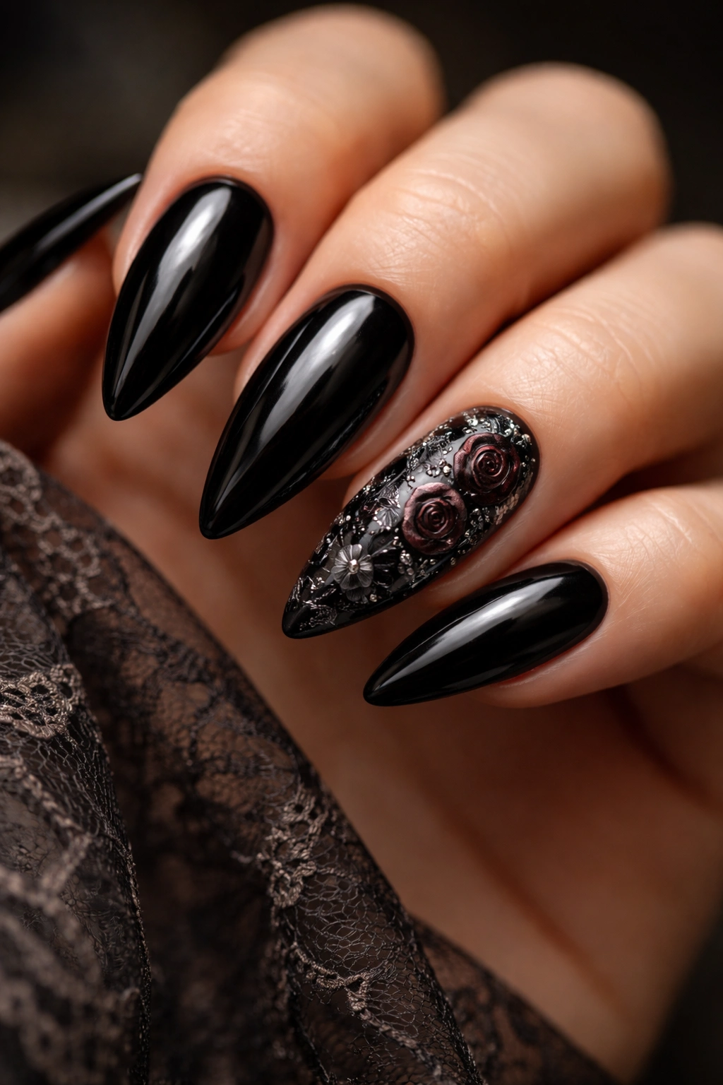 Black almond nails with gothic floral design in silver on a black base