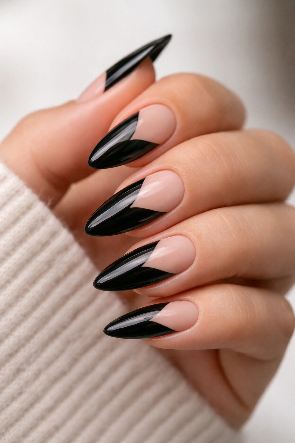 Close-up of black almond nails with negative-space design