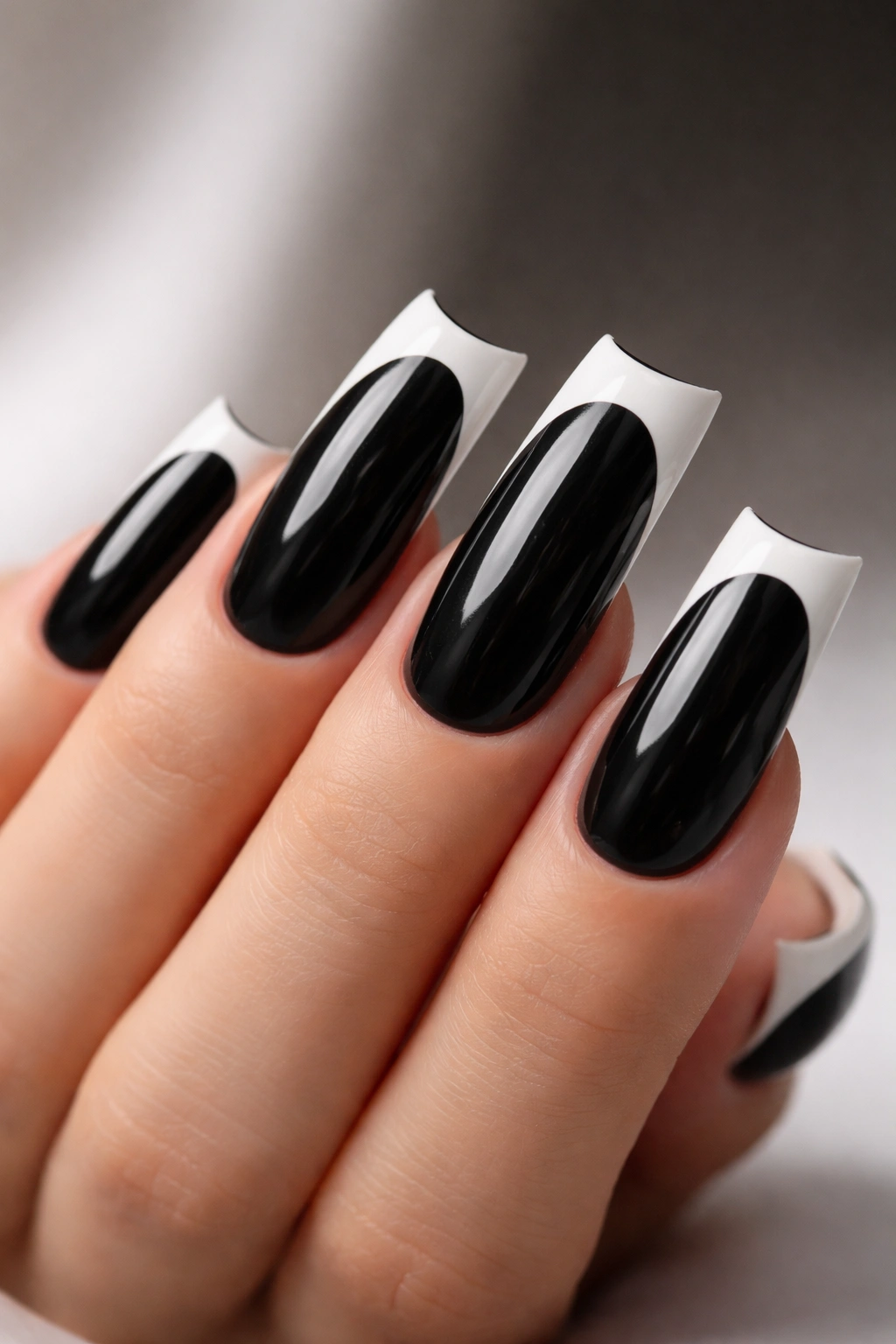 Long duck nail with black base and white negative-space French tip