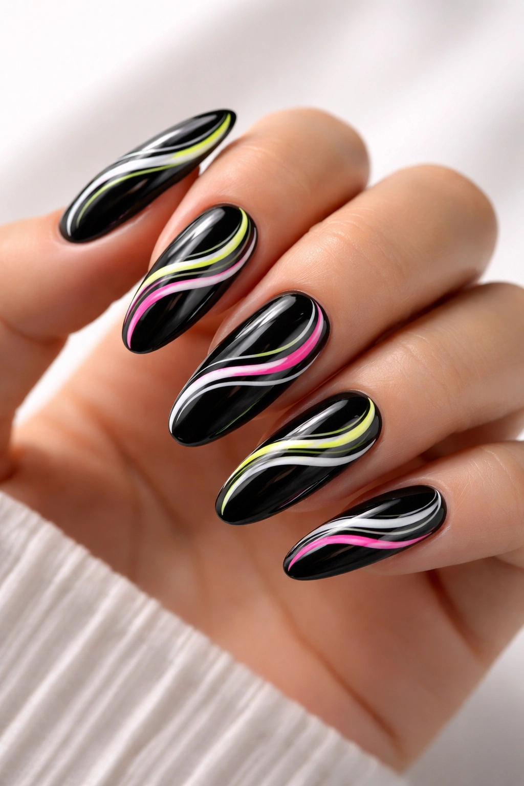 Close-up of black base nails with white neon swirls