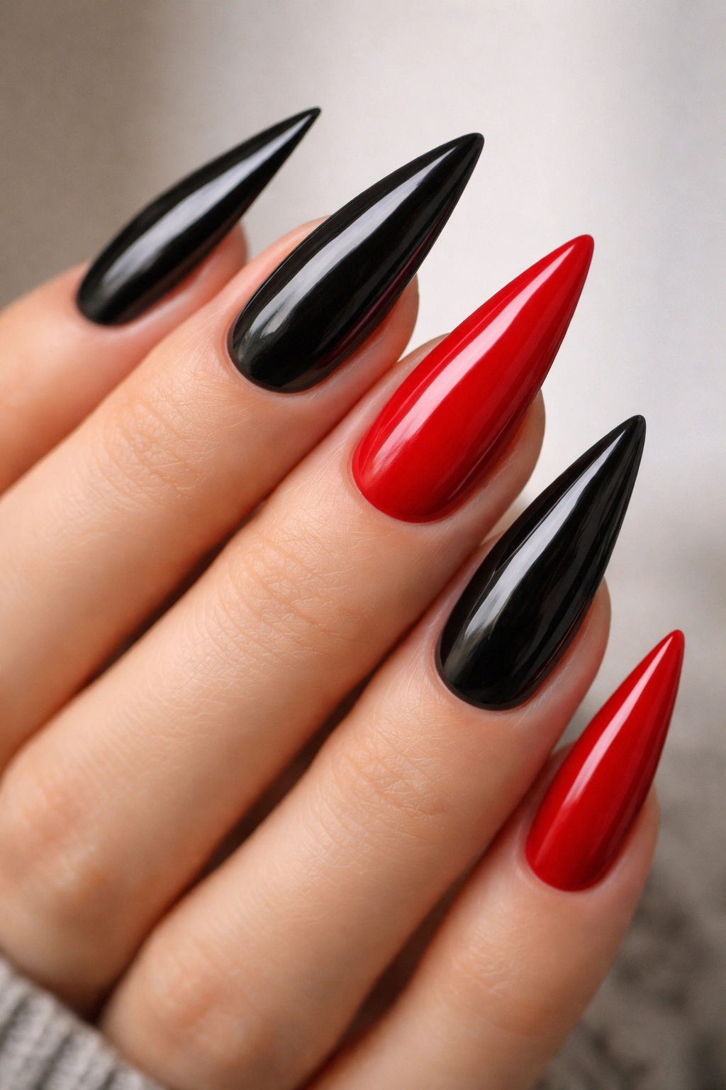 Close-up of black stiletto nails with red accent nails