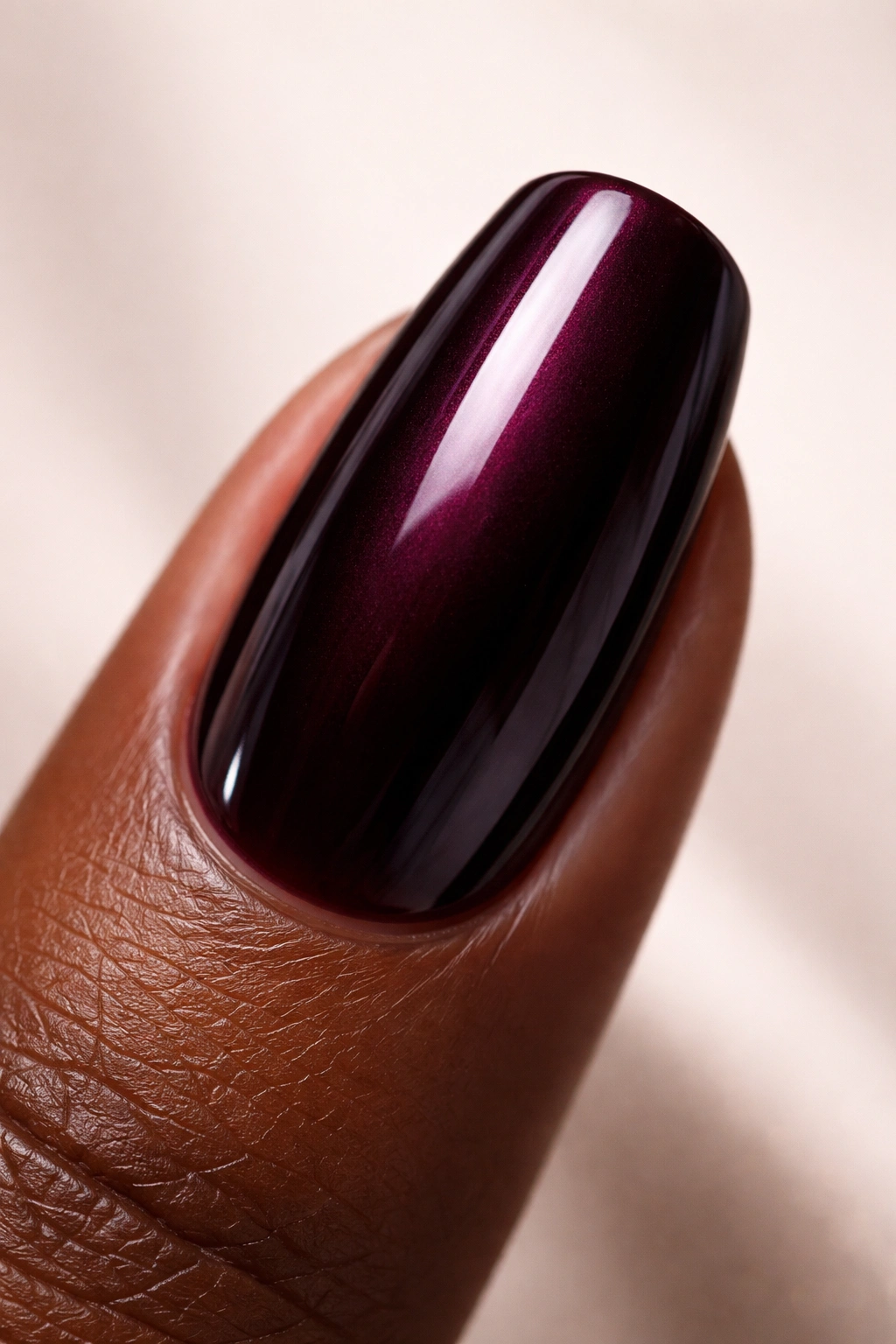 Close-up of a fingernail painted black cherry
