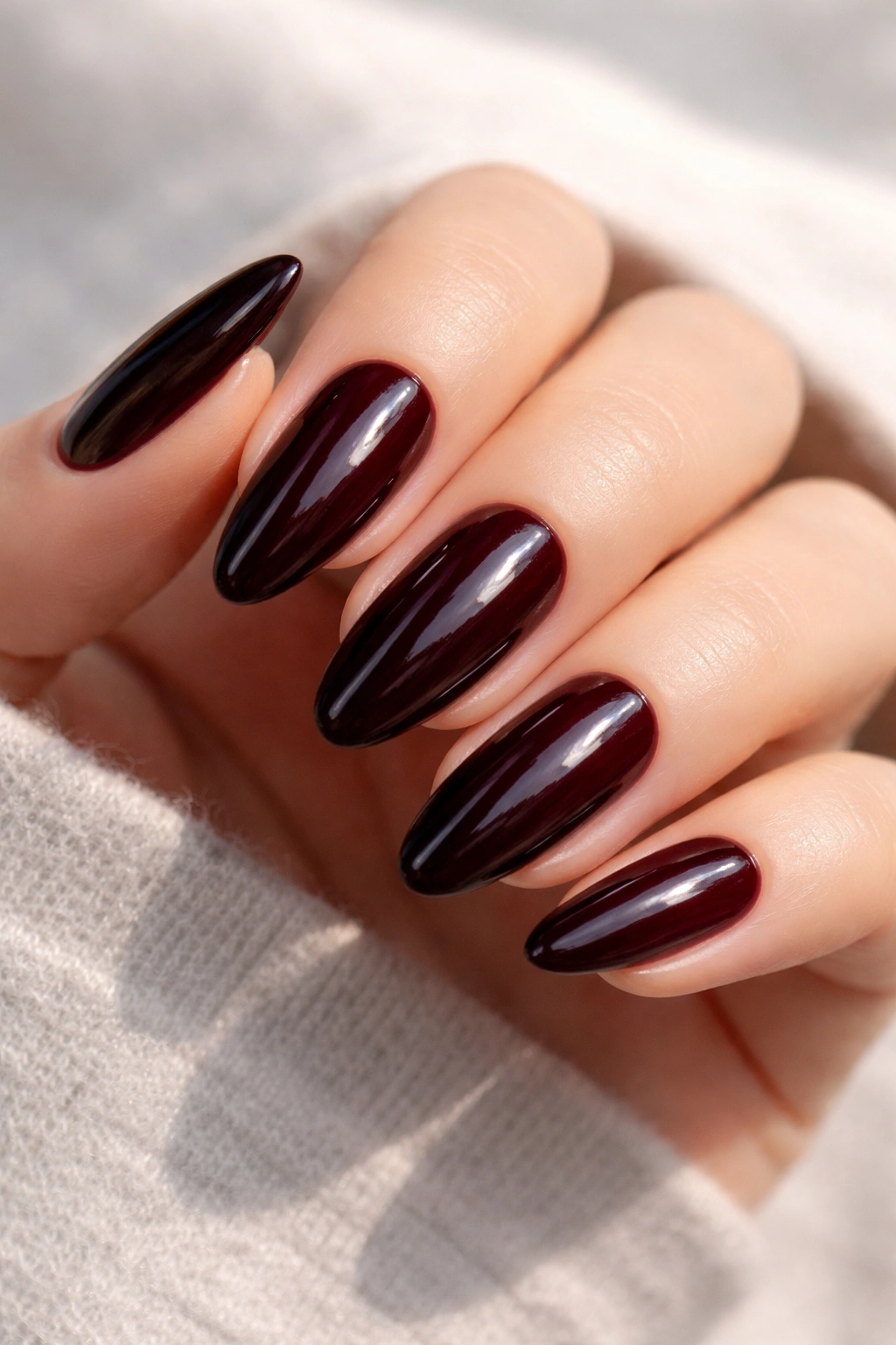 Close-up of black cherry nails with deep glossy jelly finish