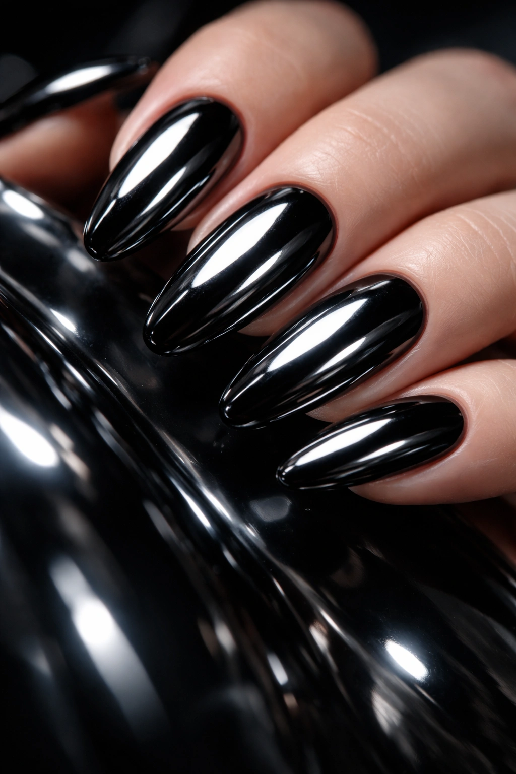 Close-up of nails with reflective black chrome finish