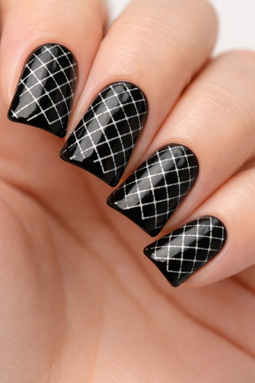 Close-up of black duck nails with white crosshatch pattern