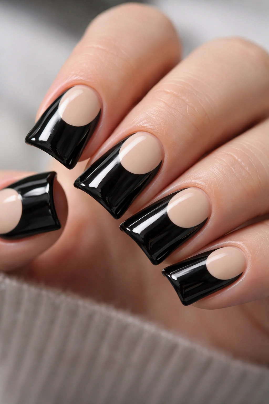 Close-up of short black duck nails with a negative-space crescent moon design