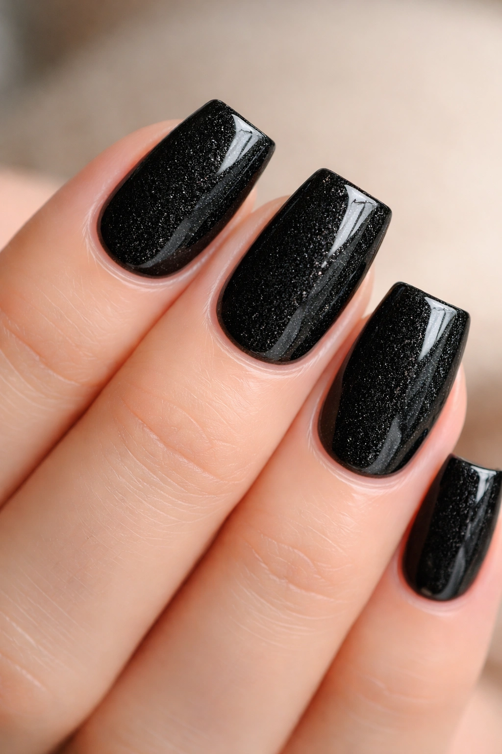 Close-up of black duck nails with subtle texture and glossy topcoat