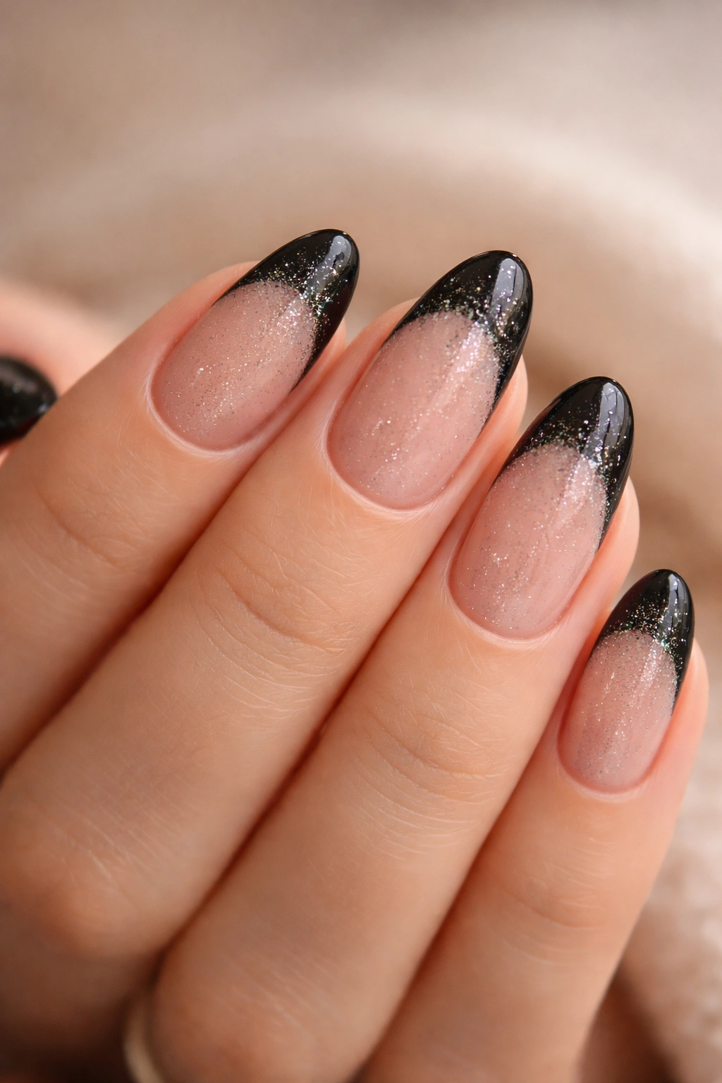 Black French nails with fine glitter dust creating a subtle glow