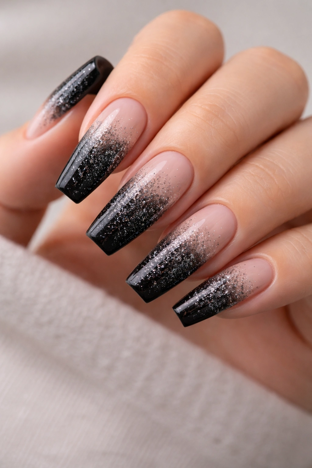Nails with black glitter fade from tip to mid-nail on ballerina nails
