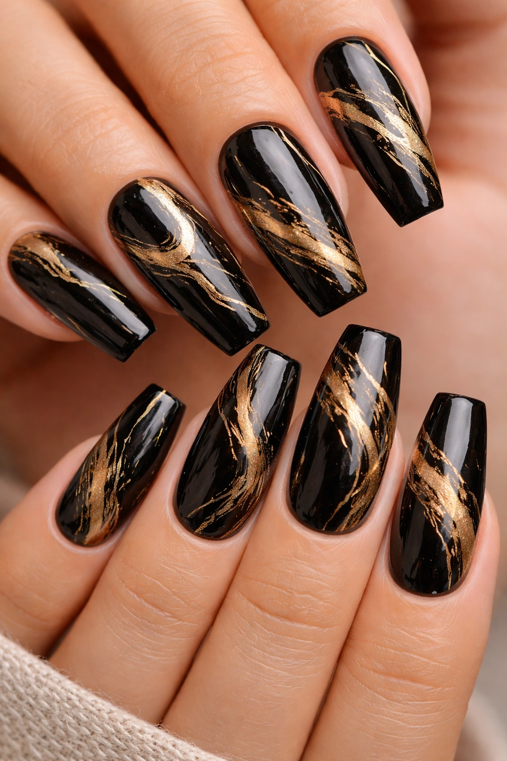 Black and gold marble nail design on coffin nails