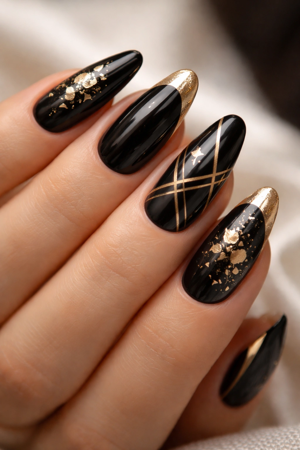 Close-up of nails with black base and gold accents.