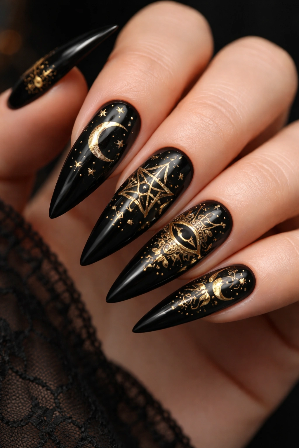 Close-up of black nails with gold occult symbols
