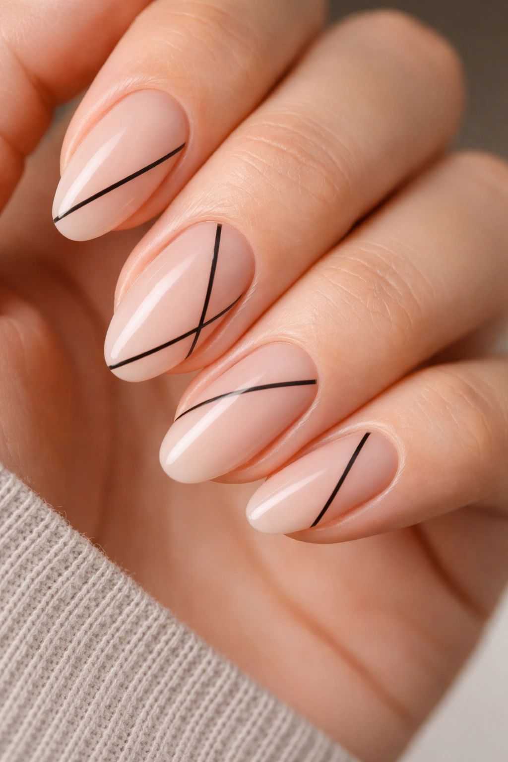 Black line art on nude short almond nails