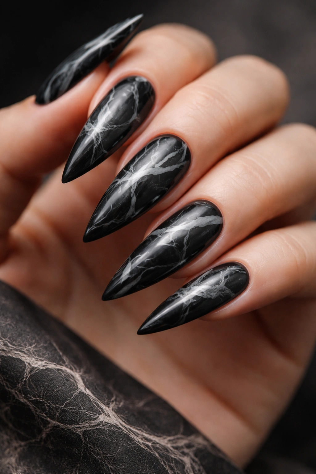 Black nails with white and gray marble swirl design