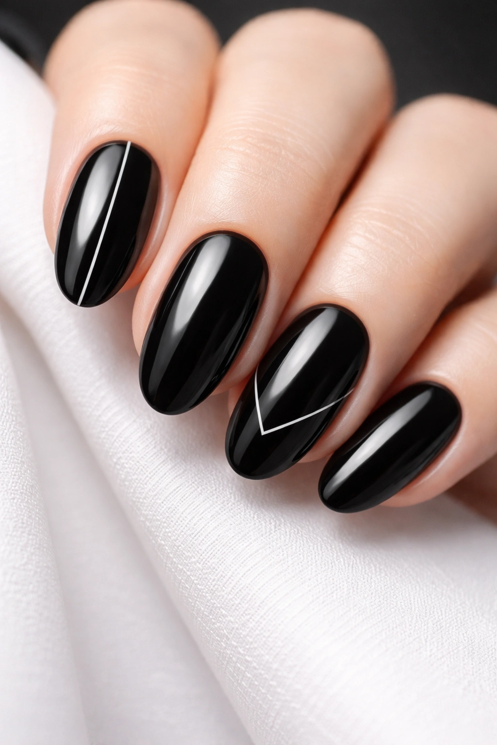 Close-up of black nails with minimalist white line art