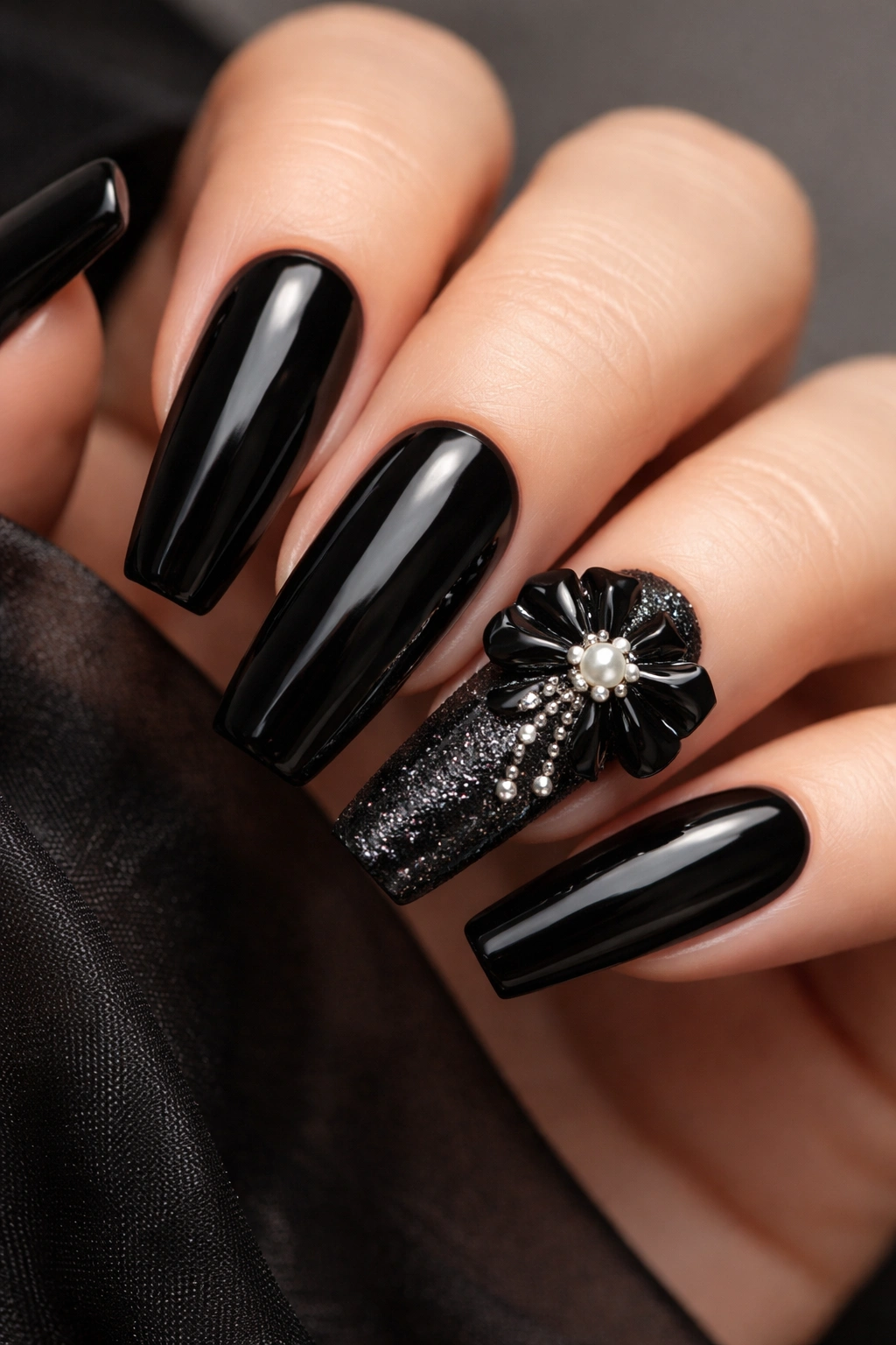 Nails with black base and 3D embellishment accent nail