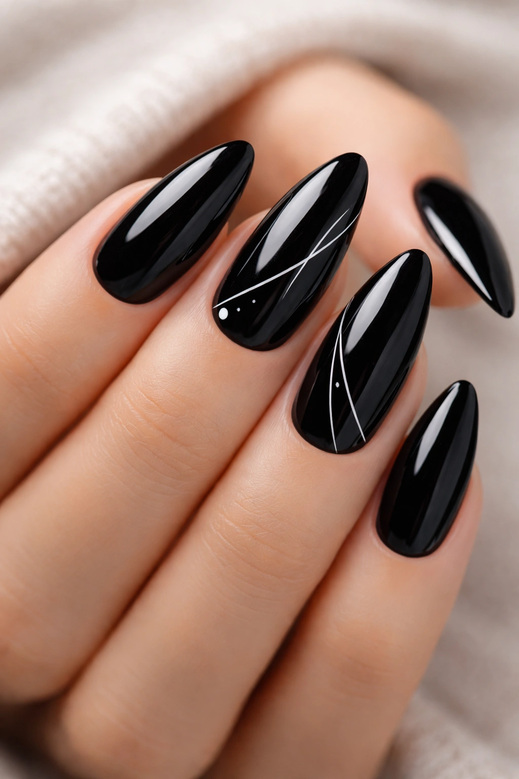 Almond-shaped black nails with white minimalist line art