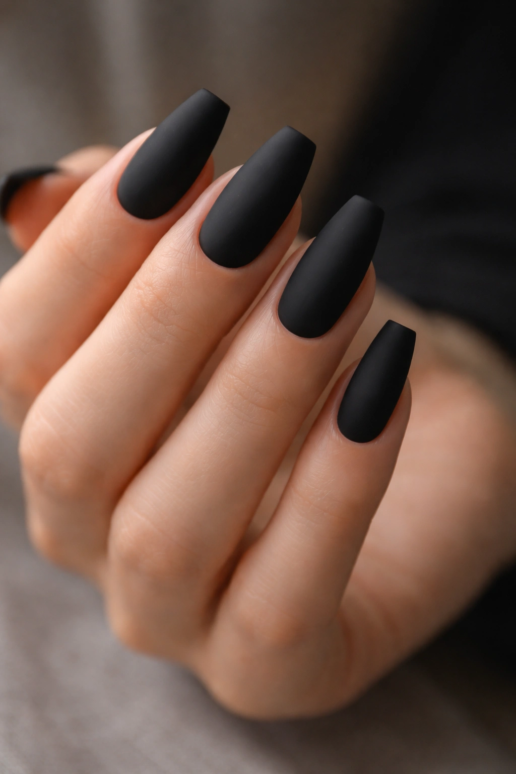 Close-up of matte black ballerina nails with straight-edge tips