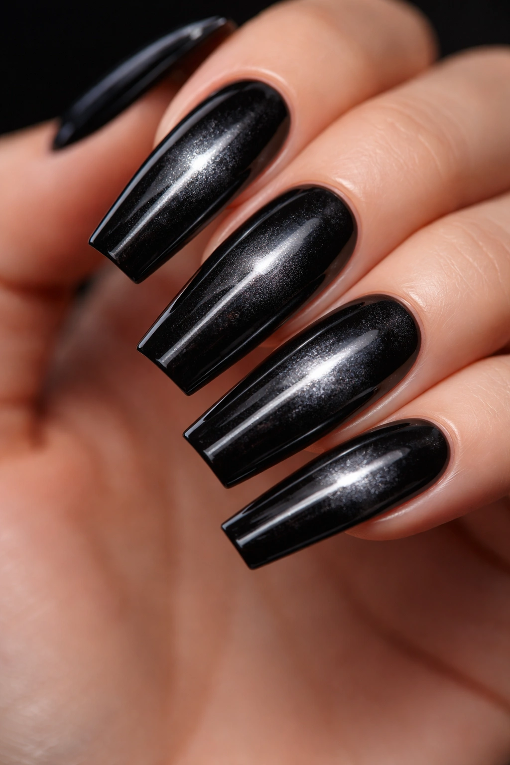 Close-up of black coffin nails with cat-eye magnetic effect