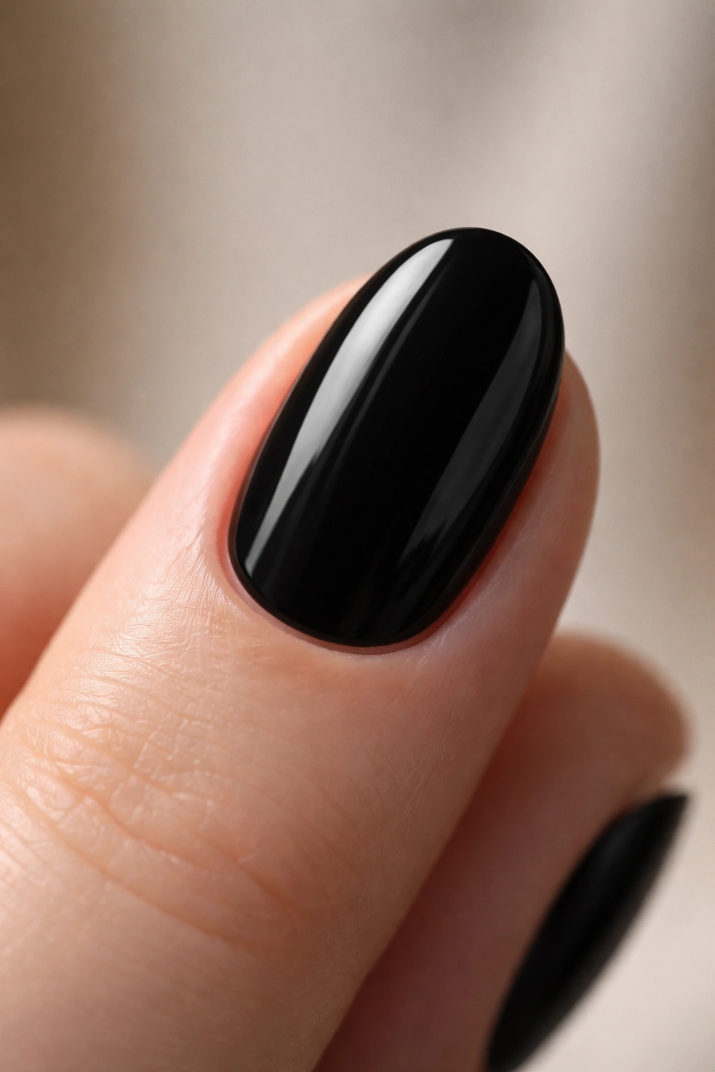 Close-up of clean short oval black nails with tidy cuticle lines