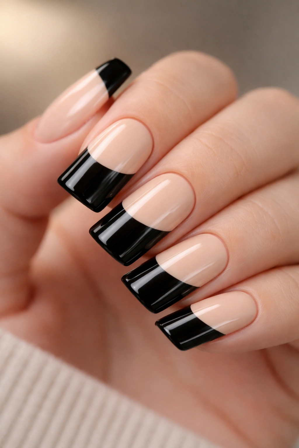 Close-up of black duck nails with black and nude color block on short nails