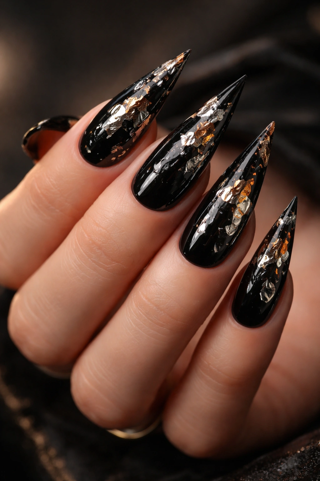 Black nails with torn foil fragments