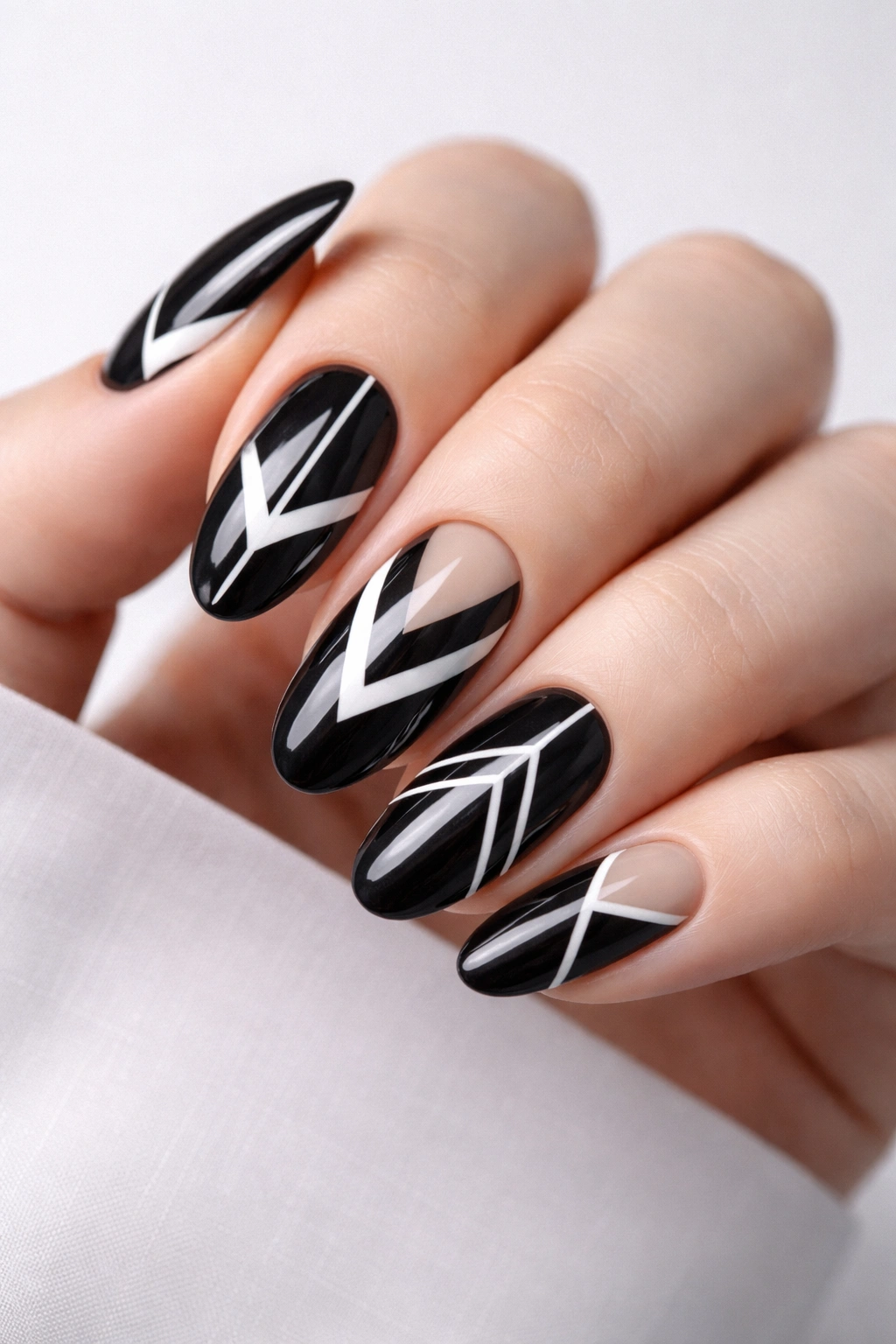 Close-up of black nails with white geometric patterns