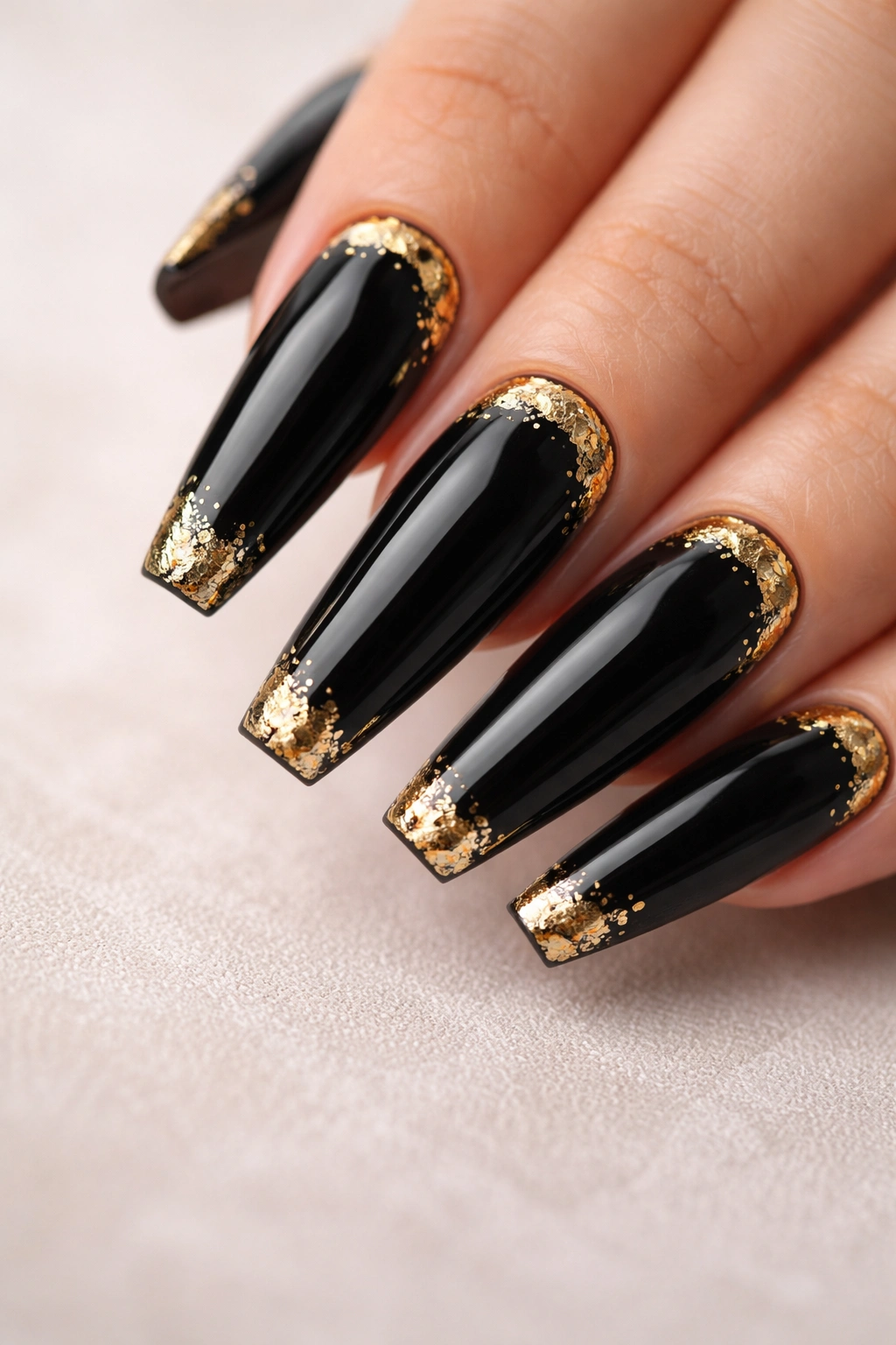 Black nails with delicate gold leaf accents