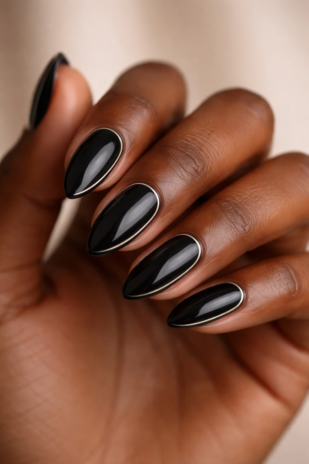Close-up of black almond nails with a single minimal line art on dark skin