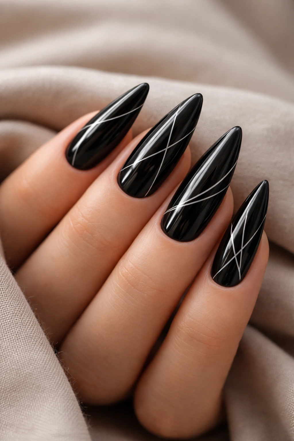 Close-up of black stiletto nails with minimalist white line art