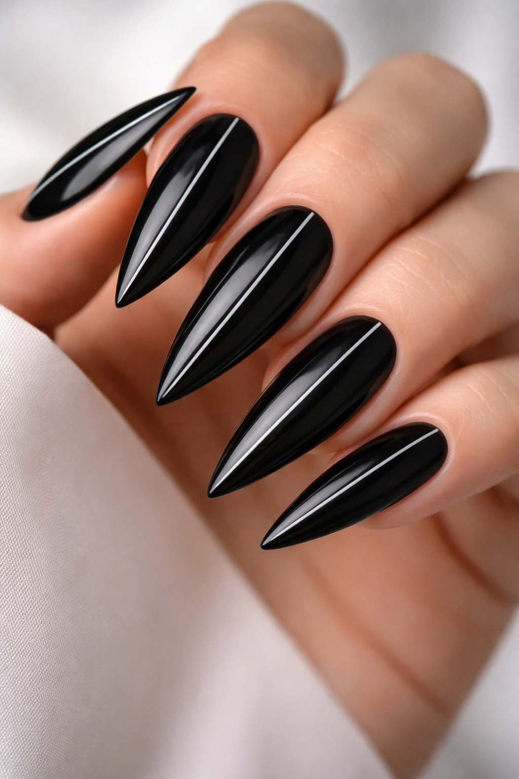 Close-up of black nails with fine white line detailing