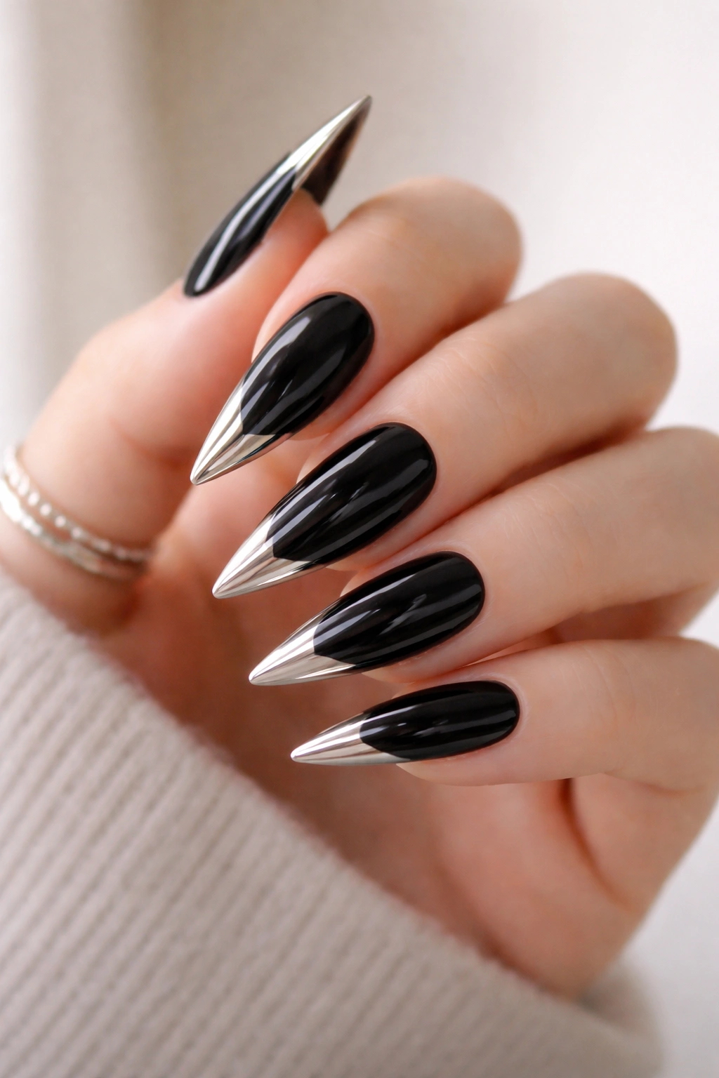 Black nails with metallic gold tip on each nail