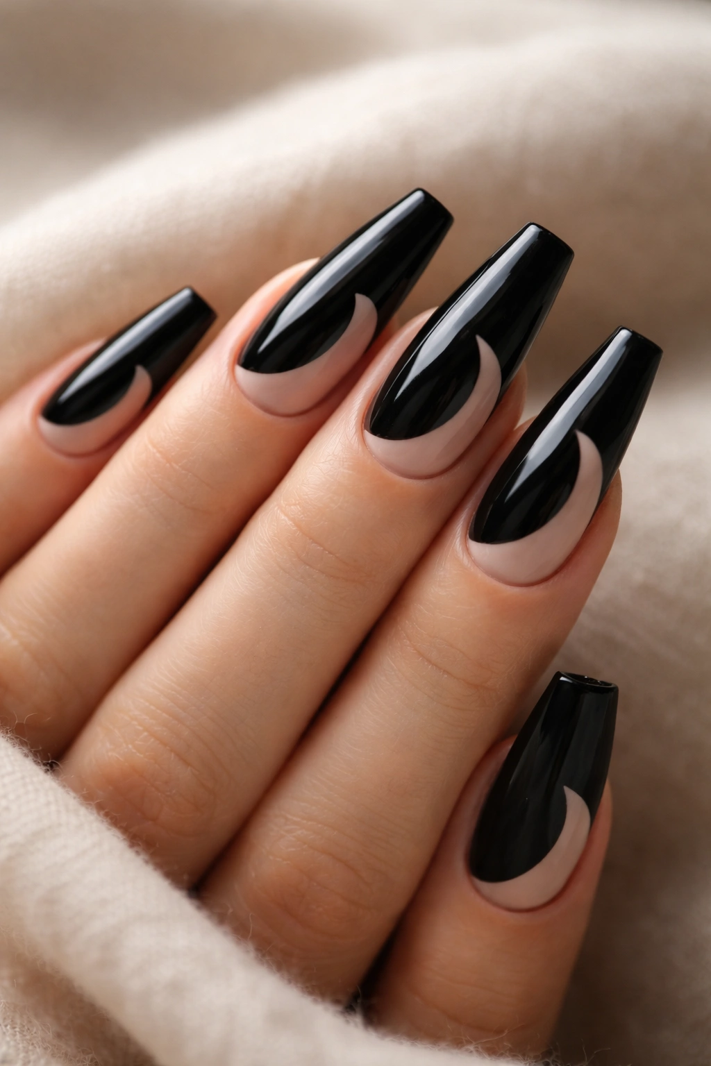 Black coffin nails with negative-space crescent moon design.